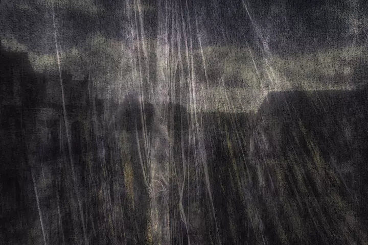 Le visage de la mort saisi au travers d'un voile dans un paysage citadin.